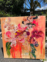 Load image into Gallery viewer, Abundance of blooms in pale pink, hot pink, burgundy and cream with splashes of bright orange on a pale apricot background. View of artwork outdoors.
