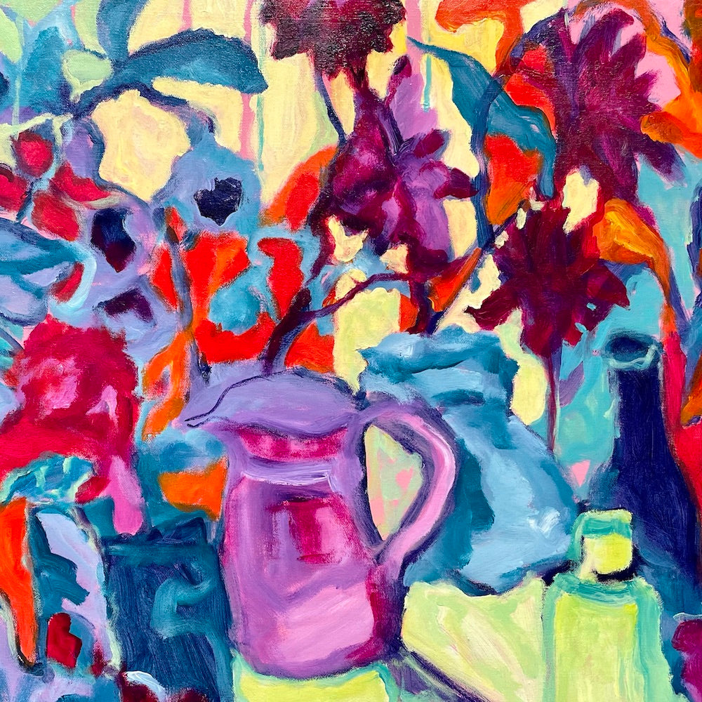 A purple jug surrounded by vividly coloured flowers and plants. Square view.