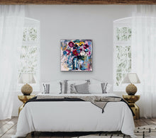 Load image into Gallery viewer, Vase of multi-coloured abstract blooms. In situ on a bedroom wall.
