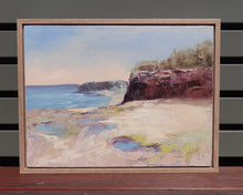 Load image into Gallery viewer, Ocean and rock pools in soft pastel colours with reddish brown cliffs. Framed view.
