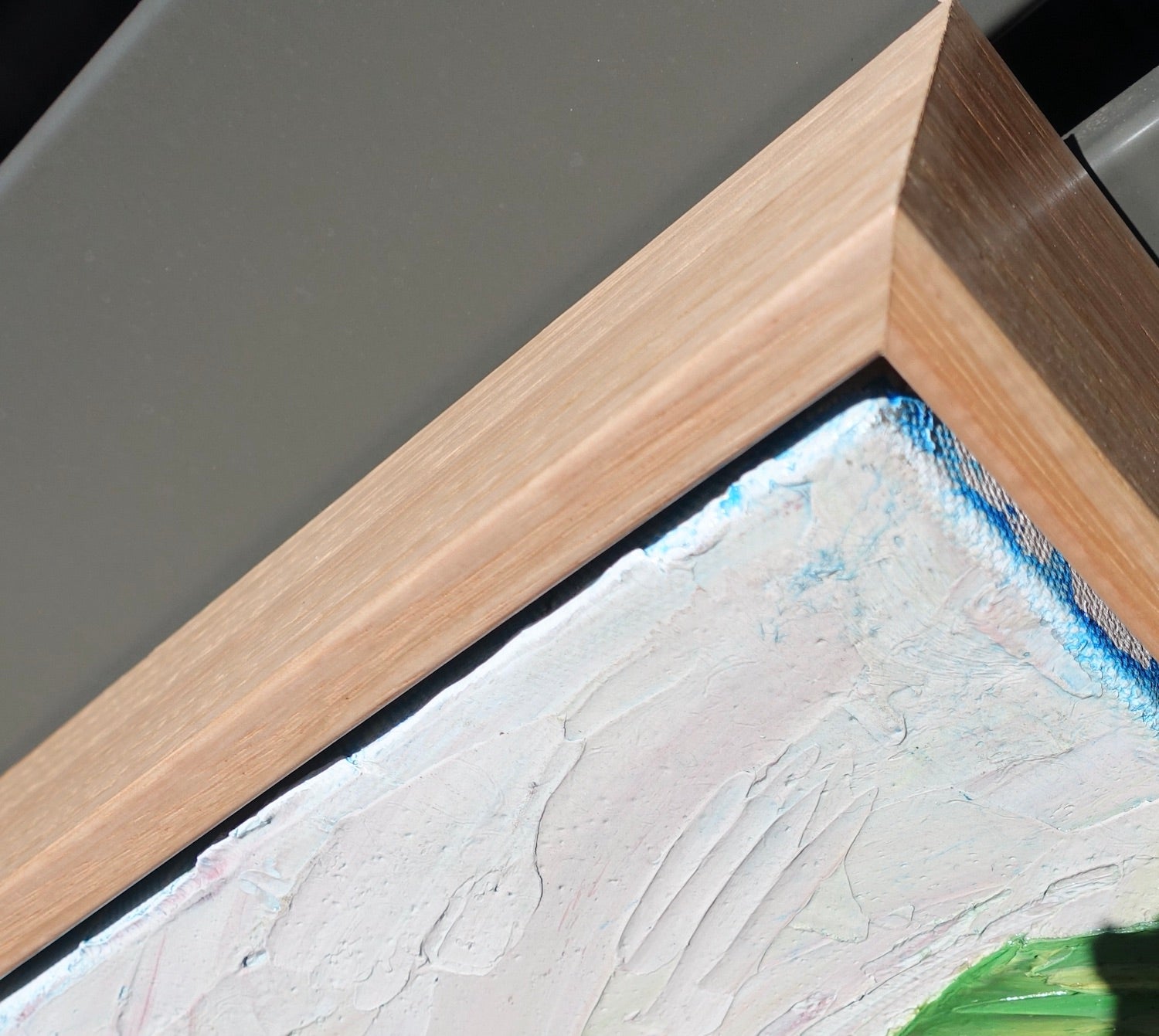 Abstract landscape of rolling green and yellow hills and a winding pink road.  Close up of frame.