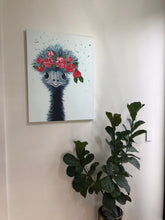 Load image into Gallery viewer, A quirky colourful painting of an emu with roses in her hair. Shown in Situ on a white wall.
