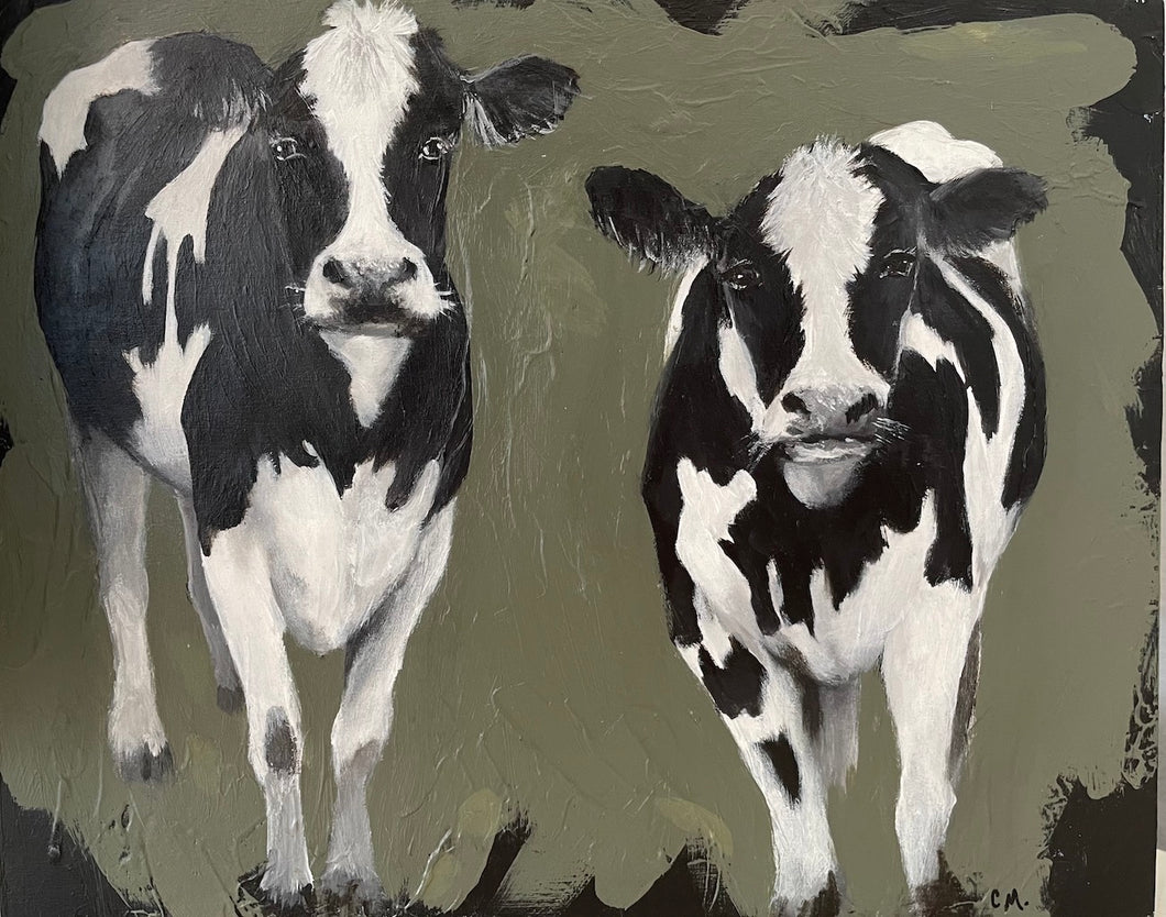 Two black and white cows standing side by side, gazing ahead, against an olive green and black background. 