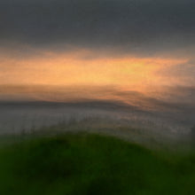 Load image into Gallery viewer, Square shaped image of a misty view of a grassy headland looking out to sea, with a touch of yellow and gold in the sky
