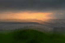 Load image into Gallery viewer, Misty view of a grassy headland looking out to sea, with a touch of yellow and gold in the sky
