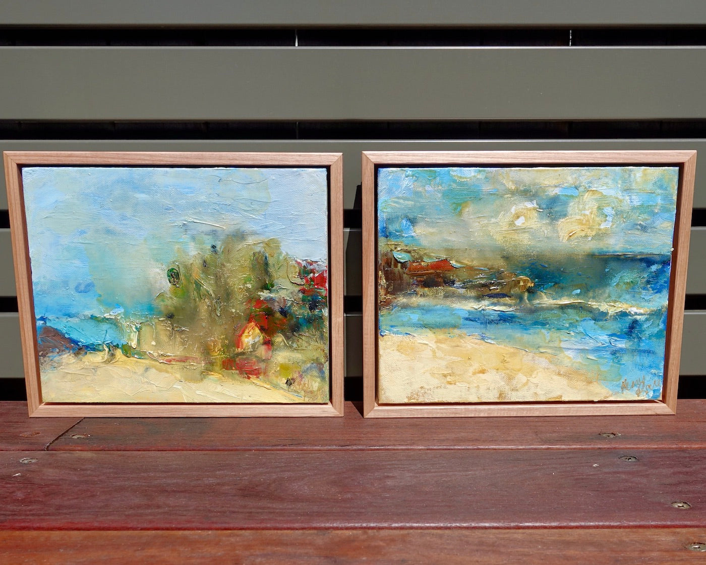 Abstract coastal scene in shades of yellow and blue. Alongside matching painting.