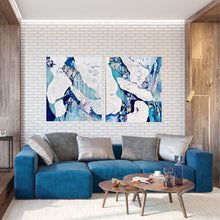 Load image into Gallery viewer, Abstract oil painting in white and blue with small multi-colours depicting stained glass. Shown on a brick wall with a matching artwork.
