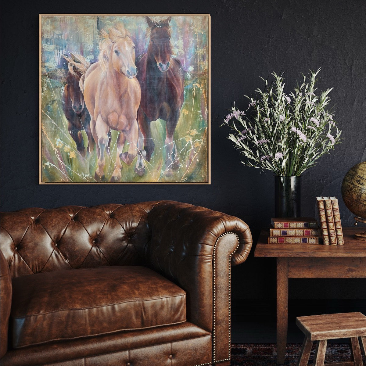 Two black horses and one caramel coloured horse in a multi-coloured pastel field. In situ on a black wall.