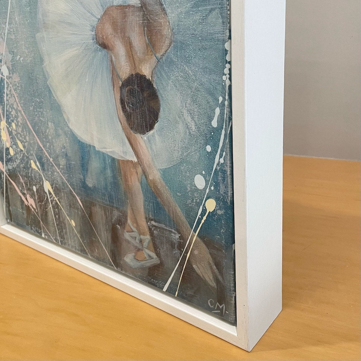 Ballerina in a white tutu bowing to the audience against a pastel blue background. Detail view.