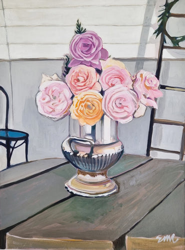 A silver vase filled with ten pastel coloured roses from the curated gardens of historic 
