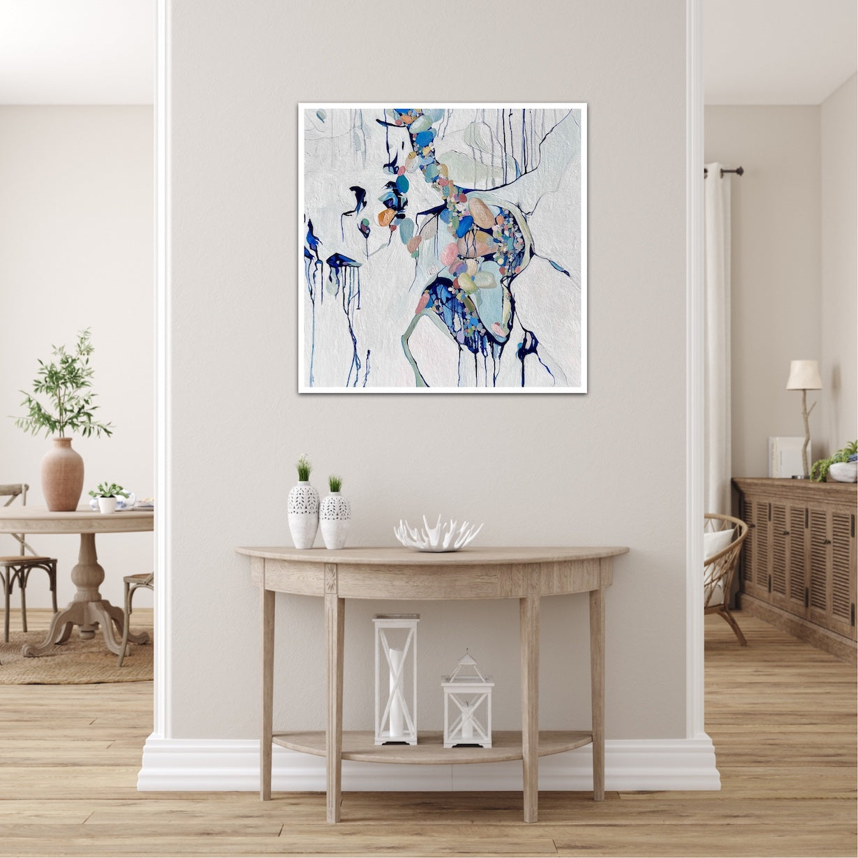 Abstract painting of a cluster of stones in a tidal pool with a background of mostly white with blues and multi coloured detail.  Shown on a dividing wall.