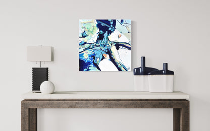 Contemporary abstract painting in shades of blue, aqua, turquoise, green, pink, ochre and white. Shown on a beige wall.