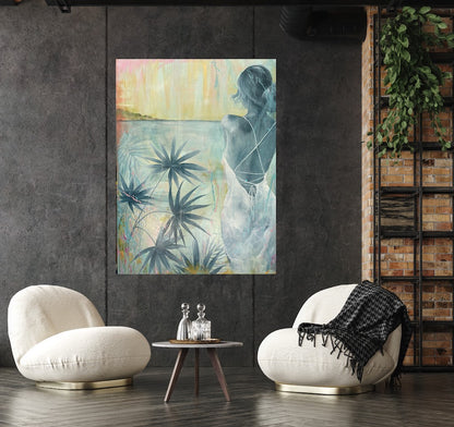Painting of a girl standing in a white dress gazing across the ocean at dawn. Shown in situ on a dark grey wall in a living room.