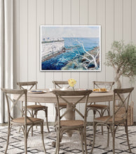 Load image into Gallery viewer, Abstract painting showing a headland jutting out into the ocean, in shades of blue and white. Shown on a panelled wall.
