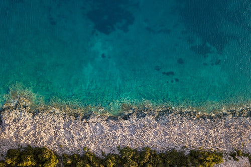 A bird’s eye view of the rocky Adriatic coastline.
(Voda = Water in Croatian). Hvar, Croatia.
