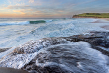 Load image into Gallery viewer, Water streams over the rock platform at sunrise. Gerringong, Australia
