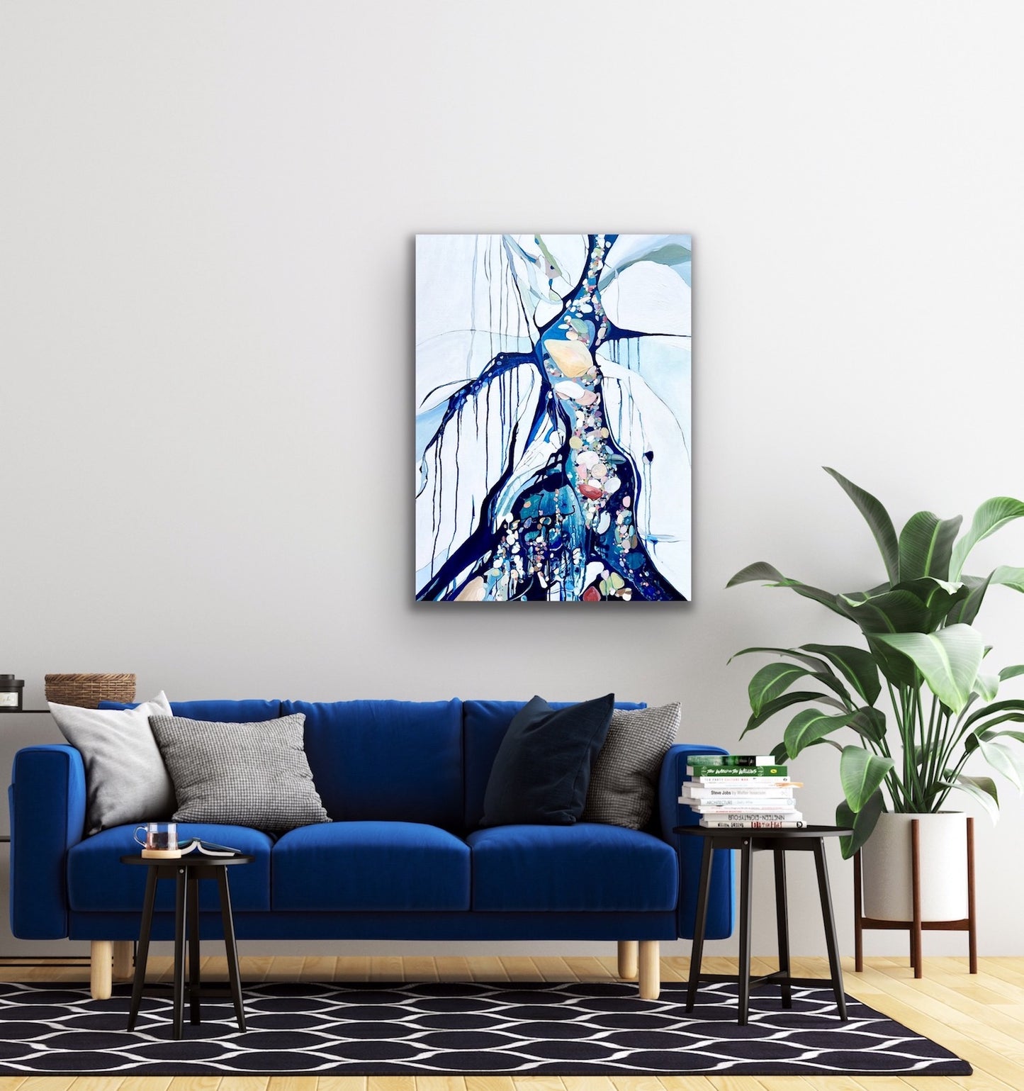 Abstract rockpool in a myriad of shades including blue, white aqua turquoise and rose and pink.  Shown on a pale grey wall above a royal blue velvet sofa.