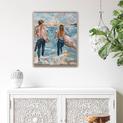 Surf painting with a man and woman standing on the edge of the ocean with surfboards under their arms. Shown on a white wall.