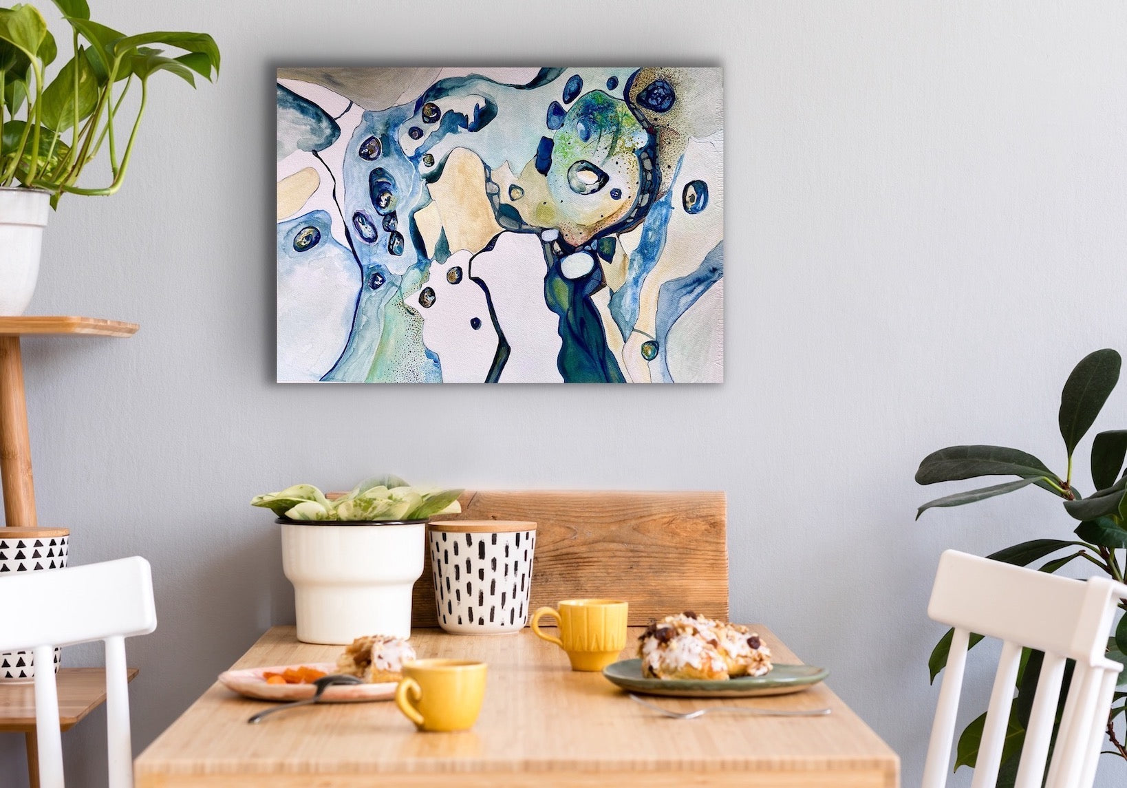 Contemporary abstract painting in shades of blue, turquoise, teal and sand. Shown on dining room wall.