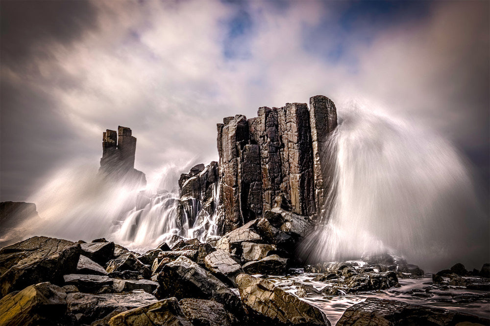 Monolithic rocks with waves crashing over the top, NSW South Coast.