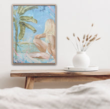 Load image into Gallery viewer, pastel painting of a girl in a bikini sitting under a banana tree. Shown in situ on a white wall above a timber bench and a white vase of dried leaves.
